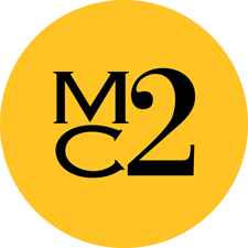Yellow circle with black 'MC2' text logo.